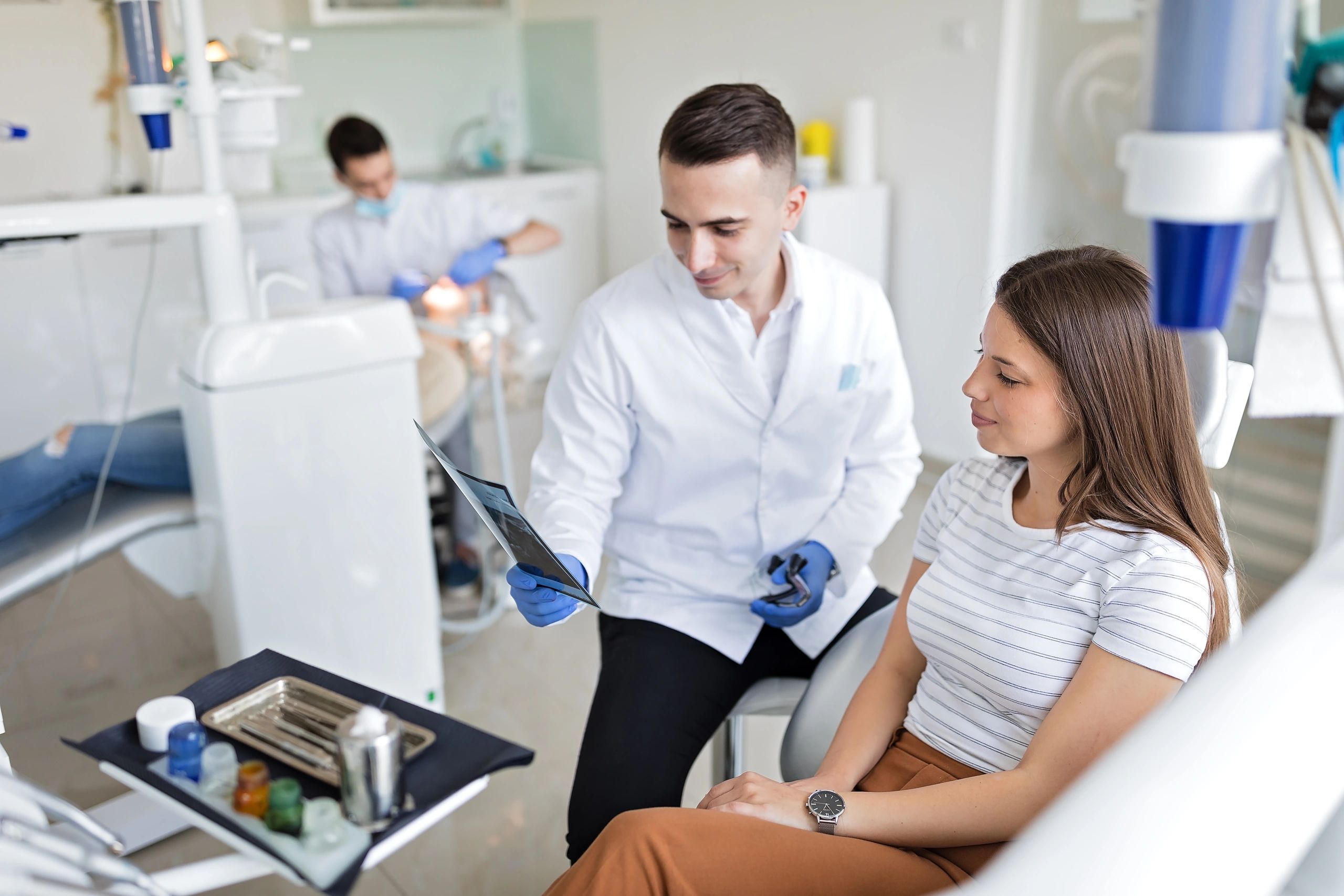 Dental professional reviewing imaging and treatment data in a modern clinical setting